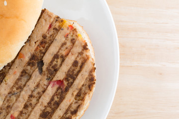 Veggie burger on a plate atop a wood table