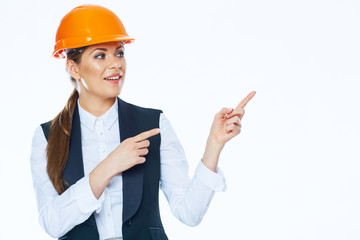 Woman builder points finger on copy space.