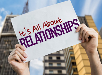 Its All About Relationships placard with urban background