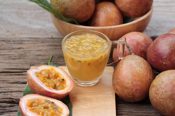 Passion fruit smoothie is delicious on wood background.