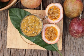 Passion fruit smoothie is delicious on wood background.