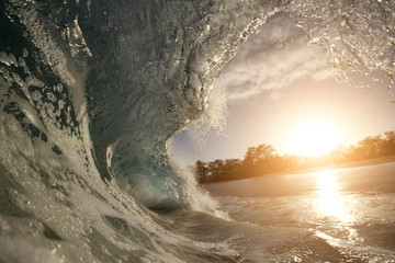 rough colorful ocean breaking surf wave falling down at sunset time
