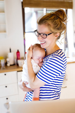 Happy mother with baby at home