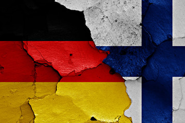 flags of Germany and Finland painted on cracked wall