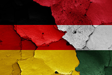 flags of Germany and Hungary painted on cracked wall
