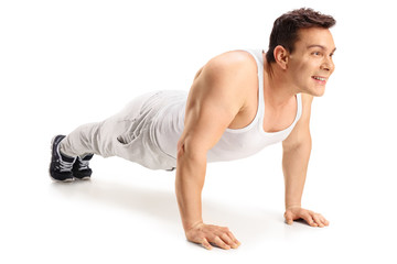 Fototapeta na wymiar Muscular guy doing push-ups