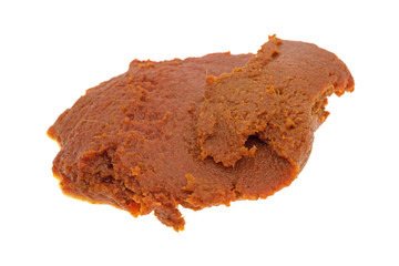 Blob of red curry paste on a white background