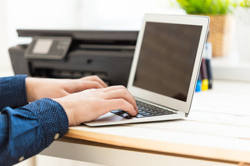 Man's hand making copies. Working with printer