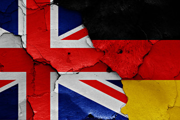 flags of UK and Germany painted on cracked wall