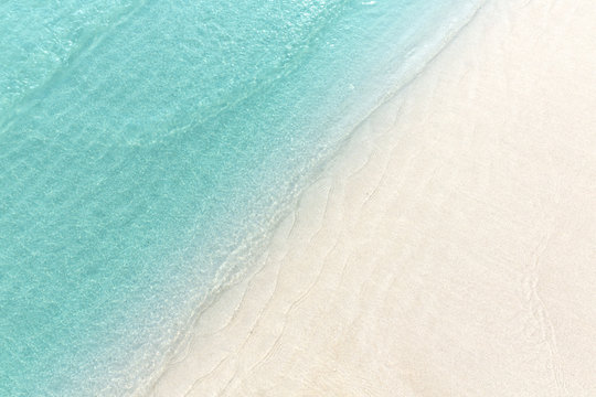 Fototapeta Close up blue sea water waves on white sand beach,Beautiful blue sea beach with white sand, Beautiful blue ocean beach close up shot, Clean beach with blue sea in Thailand