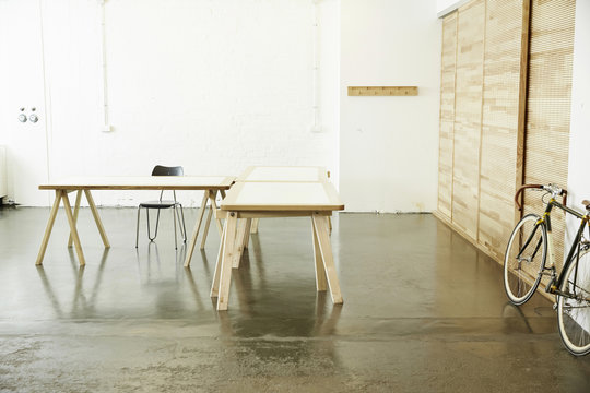 Desks and racing cycle in a studio