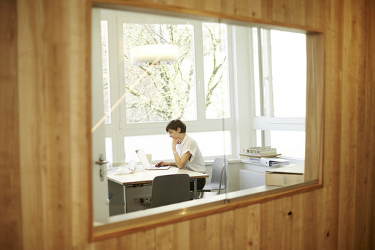 Architect using laptop in her office