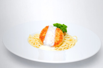 Spaghetti with chicken meatballs on a white background