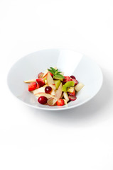 Fruit salad on a white background with berry
