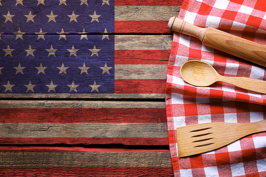 Checkered napkin and cutlery on wooden background. American cuisine food concept