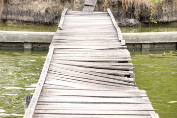 Old wreck wooden bridge for crossing the river.