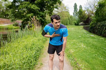 Man runner chest cramps after running. Jogging man with chest  pain after jogging work out.