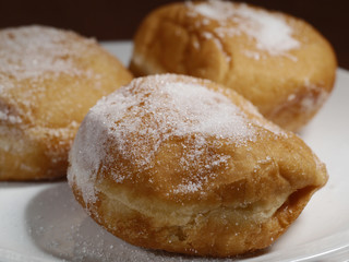 Three donuts on a plate. 