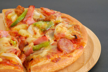 Pizza on a wooden tray.