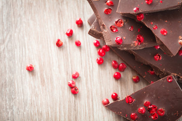 Pieces of dark chocolate with pink pepper