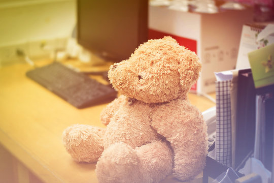teddy bears sitting on the desk