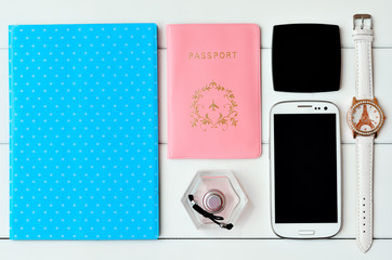 Notepad, passport, watches, perfume, phone, mirror on a white background. Set of female accessories