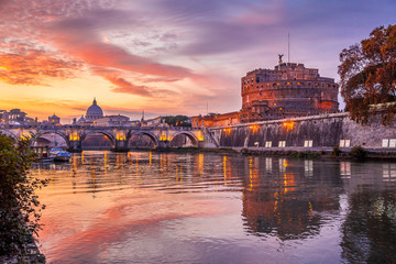 Beautiful sunset on Tiber, Hadrian Mausoleum and Saint Peter Basilica, Rome
