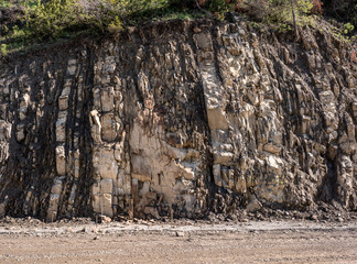 Mountains road under construction. Construction of a retaining wall.