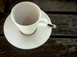White empty coffee cup on wooden table