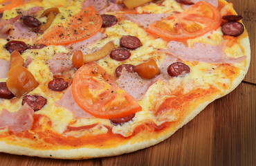 Tasty Italian pizza on wooden background