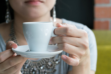 Young woman having coffee break
