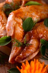 Green herbs placed on marinated chicken wings