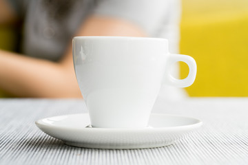 espresso coffee in thick white cup in a cafe, super shallow doc
