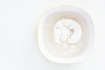 Fototapeta na wymiar Coconut milk from a can on a white background