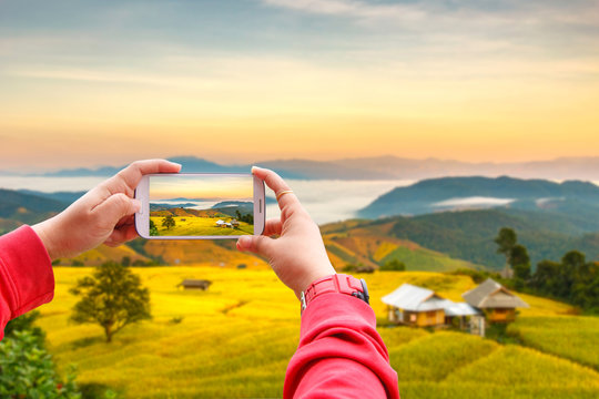 Smartphone photographing Sunrise at Terraced Paddy Field in Mae-Jam Village , Chiang Mai Province , Thailand
