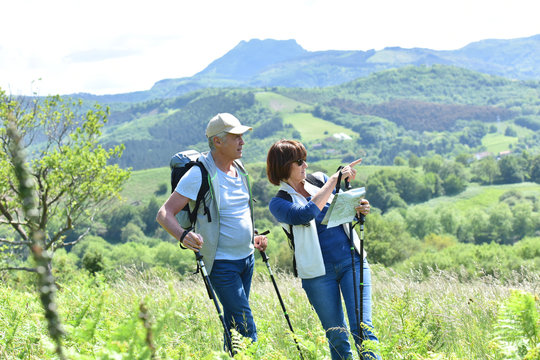 Senior Couple On A Hiking Day Looking At Map