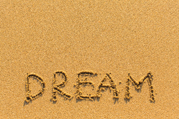 Dream - word drawn on the sand beach.