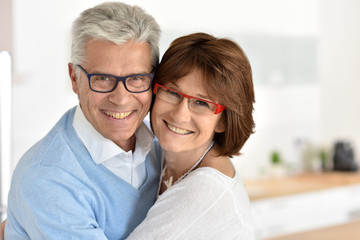 Portrait of smiling senior couple at home