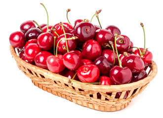 Fototapeta na wymiar cherries in a wicker basket isolated on white background