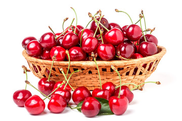 cherries in a wicker basket isolated on white background