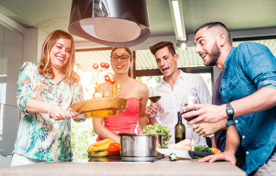 Group Of Friends Making Pasta Party And Having Fun In The Kitchen