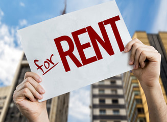 For Rent placard with urban background