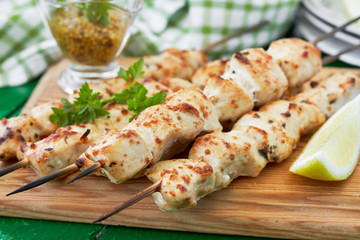 Chicken shish kebab on skewers with a lemon and parsley. horizontal