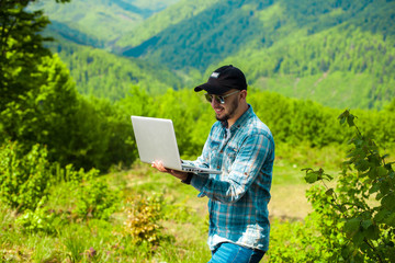 man working on laptop in the fresh air