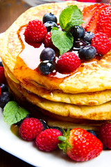 Pancakes with berries and maple syrup