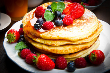 Pancakes with berries and maple syrup