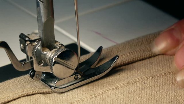 Close up Video of Sewing Machine  - Sew A Dress In A Textile Factory. Slow Motion Full Hd Stock Footage Clip.
