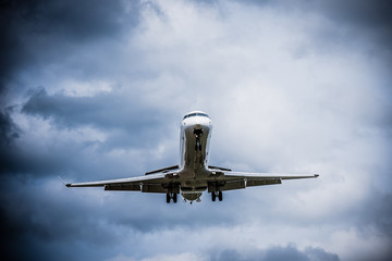 Airplane flying with clouds in background