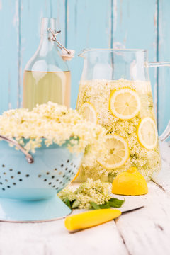 Elderflower and lemon slices in a jug for making elderflower syrup.
