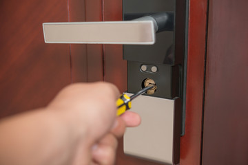 trying to open a door lock by screw driver